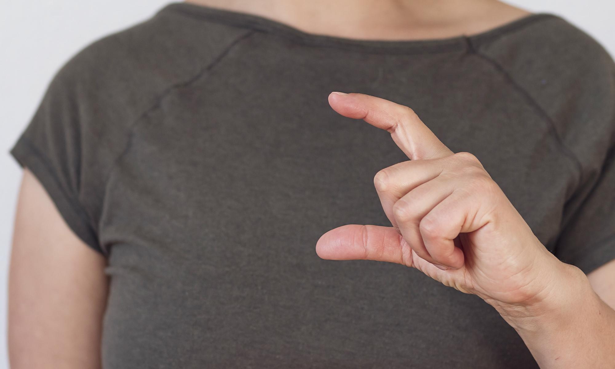 Woman's hand making gesture used in test for Parkinson's disease.